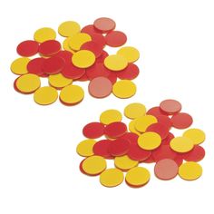 two pieces of red and yellow confetti sitting on top of each other in the shape of circles