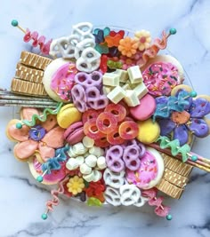 a plate full of colorful donuts and candy on top of a marble countertop