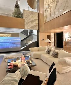 a living room filled with furniture and a flat screen tv mounted to the side of a wall