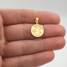 14k Solid Gold World Map Necklace, Personalized World Map Pendant, Earth Pendant, World Map Necklace, 14k Real Gold Earth Necklace **Photos and video are both for the 14mm diameter option**  Pendant Description : Pendant Material: 14k Solid Gold Metal Stamp: 14k Pendant Thickness: 0.5mm -Options for pendant diameter --14mm / 0.55 inches --18mm / 0.705 inches (diameter of Dime) -The inner dimensions of the bail is about 4 x 4 mm Chain description: Chain Material : 14k Solid Gold Chain Thickness: 0.7 mm -Chain length: --40cm /15,7 inches --45cm /17,7 inches --50cm /19,6 inches --55cm /21,6 inches ✔Free backside engraving option  ✔Beautiful gift box included ✔Free Worldwide Shipping with DHL Express ✔Shop's policies: Buyers are responsible for any customs and import taxes that may apply, for Personalized Pendant Necklaces For Travel, Silver World Necklace, Globe Necklace, Gold World Map, World Map Necklace, Map Pendant, Map Necklace, Solid Gold Chains, Fancy Jewelry