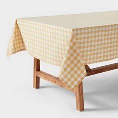 a wooden bench with a checkered tablecloth on it