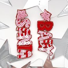 Get into the festive spirit with our Santa Baby pink and red Christmas Dangle Earrings!  These playful earrings feature one dangle seed bead earring that says "Santa" and the other "Baby," adding a touch of whimsy to your holiday look. The combination of pink and red hues creates a fun and vibrant accessory that embodies the true essence of Pinkmas joy. Make a statement with these merry earrings, perfect for the holiday season. Whether you're looking for a unique Christmas accessory or a gift that stands out, our Santa Baby earrings are the ideal choice. 🌟 Spread the holiday cheer and add festive flair to your ensemble with these delightful earrings. Get ready to jingle all the way and make your Christmas celebrations extra special! 🎁 🌸 Elevate Your Style with Trendy Earrings! 🌸 Welcom Personalized Pink Jewelry For Christmas, Festive Red Beaded Earrings For Pierced Ears, Festive Red Beaded Pierced Earrings, Red Beaded Earrings For Festive Occasion, Red Beaded Earrings For Party, Red Jewelry For Christmas Birthday, Personalized Earrings For Valentine's Day Party, Red Christmas Earrings For Party, Red Festive Earrings For New Year