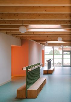 an empty room with benches and lights on the ceiling