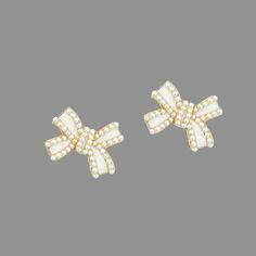 Petite bow shaped post earrings with ivory pearl detail. 14k Gold plated. Hypoallergenic. Measures at approximately 1 inch diameter. White Bow Jewelry For Formal Occasions, White Formal Jewelry With Bow Detail, Formal White Jewelry With Bow Detail, Formal White Bow Jewelry, White Bow Earrings For Anniversary, White Bow Jewelry For Anniversary, Ivory Pearl, Bow Earrings, Post Earrings