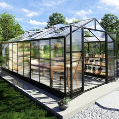 a glass house sitting on top of a lush green field