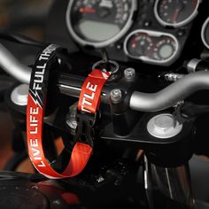 the handlebars and gauges on a motorcycle are red with white lettering that reads,'tweetee city '