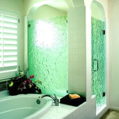 a bath tub sitting next to a walk in shower