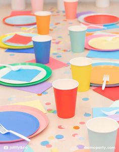 colorful paper cups and plates on a table