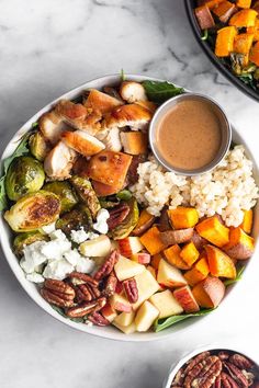 two plates filled with different types of food on top of a white table next to each other