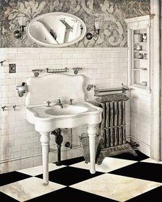 an old fashioned bathroom with black and white checkerboard flooring, antique sink and mirror