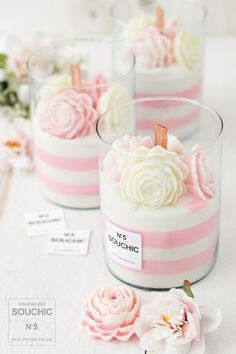 pink and white striped candles with flowers on them