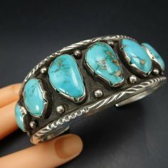 "DESCRIPTION: This exceptional bracelet will be a cherished addition to your collection of fine vintage Southwestern and Native American jewelry. MEASUREMENTS: Interior of the cuff measures 5 5/8\" with an additional 1 1/4\" non-adjustable gap. Total circumference: 6 7/8\" Measures 2 5/8\" straight across the widest part (from wrist bone to wrist bone) Bracelet face measures 1 1/4\" wide (the face of the bracelet, north to south) WEIGHT: 69.8 grams SIGNED: no STERLING: unmarked, verified sterlin Southwestern Style Stamped Blue Bracelets, Southwestern Cuff Collectible Jewelry, Southwestern Style Collectible Cuff Jewelry, Western Style Cuff Jewelry For Gift, Southwestern Blue Cuff Jewelry, Western Style Blue Cuff Bangle Bracelet, Western Style Blue Cuff Bracelet Gift, Vintage Stamped Blue Jewelry, Blue Vintage Stamped Jewelry