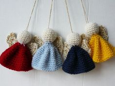 four crocheted angel ornaments hanging from chains