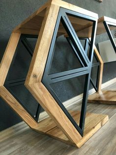 a wooden table sitting on top of a hard wood floor next to a gray wall