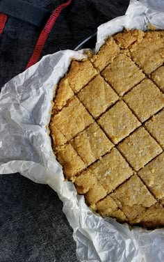 a pie sitting on top of a table covered in wax paper