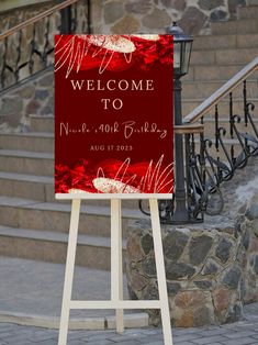 a welcome sign stands in front of some steps