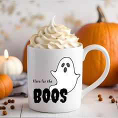 there is a coffee cup with whipped cream in the shape of a ghost on it