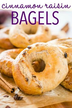 cinnamon raisin bagels on a cutting board with cinnamon sticks