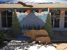 a bear and cub statue in front of a building