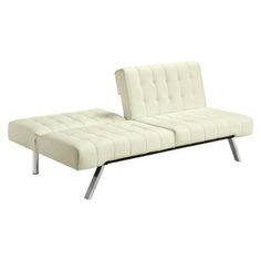 a white couch sitting on top of a metal frame