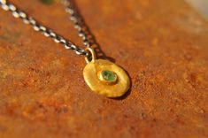 "solid 24k gold pendant//gold emerald necklace//emerald charm pendant//solid gold pendant//24k gold pendant//emerald charm//24k gold necklace 24k gold emerald pendant/charm size of pendant 10 mm approximately , (without the bail) emerald is a 3 mm facet stone. can come with a 14k chain 18\" (like in the image)with additional 100 us $ or with a 14k goldfield chain 18\" with additional 25 us $ or with an oxidized silver chain 18\" with additional 25 us $ I can make all sizes and add all gemstones, Gold Spiritual Emerald Necklace, Spiritual Gold Emerald Necklace, Gold Spiritual Round Emerald Necklace, 22k Gold Gemstone Pendant Necklace, Gold Jewelry With Coin Pendant For May Birthstone, Dainty Gold Necklace With Emerald, Spiritual Gold Emerald Gemstone Necklace, Green Necklace With Coin Pendant As Gift, Green Necklace With Coin Pendant For Gift