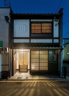 an old japanese style house with the sun shining through the window and doors on the outside