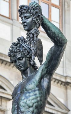 there is a statue that has an angel on it's head and hands in his hair