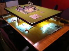 a wooden table topped with lots of cards and paper on top of it's sides