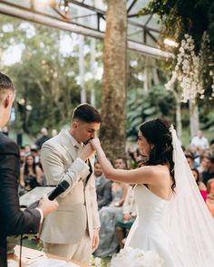 the bride and groom are getting married in front of an audience