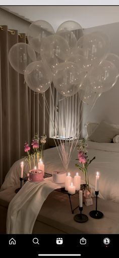 balloons and candles on a bed in a room