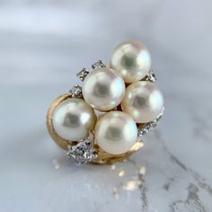 "Retro 18K yellow gold statement ring featuring a beautiful cluster of Akoya pearls. A must-have for any high-end pearl lover! Accented by .42 carat in single cut diamonds. Band is a 6.5 and sizable upon request for an additional charge. No issues to note. Hallmarked and tested. We are a brick and mortar store located in Alhambra, CA. All our items are guaranteed as described.   SPECIFICATIONS: Ring Size: 6.5 Face measures: 4/5\" in diameter Diamonds: .42ctw / SI H Color Total Weight: 9.19 grams   This ring has been inspected by professionals with over 35 years of experience to ensure its excellent condition. **Please inquire about sizing before purchase or making an offer. Order will ship within 24 hours. We offer a 14-day, no-questions-asked return policy.  Please see detailed pictures, Antique Jewelry Rings, Gold Statement Ring, Pearl Cluster, Brick And Mortar, Akoya Pearls, Detailed Pictures, Statement Ring, Rings Statement, Vintage Watches