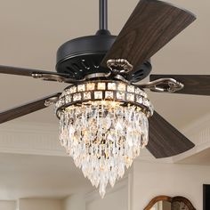 a chandelier hanging from a ceiling fan in a living room