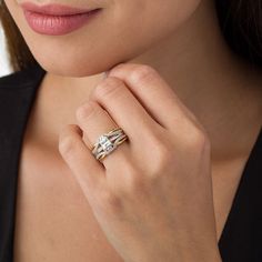 a woman wearing a gold and diamond ring