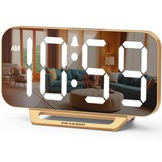 an alarm clock with the time displayed on it's face in front of a living room