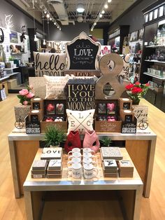 a display in a store filled with lots of items and flowers on top of a table