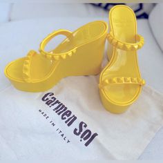 Carmen Sol Tonino Wedge Yellow Size 9 Made In Italy Brand New In Box. Never Worn! Features: Made In Italy Vegan Recyclable Rose Scented Made Of High-Quality Italian Pvc This Platform Wedge Is Made Of Our High-Quality Jelly With Studded Straps, Cushioned Inner Sole, And Well-Defined Ridges On The Outsole. They Are Water Resistant And Weatherproof. Details: Measures: 4.8” Heel, 1.5” Platform Includes: Eco-Friendly Dust Bag And Box Made In Italy Nontoxic Pvc (Prop 65 Compliant) Wedges Run True To S Chic Yellow Wedge Sandals For Party, Designer Synthetic Wedge Sandals, Designer Synthetic Platform Wedge Sandals, Yellow Platform Wedge Sandals For Summer, Yellow Summer Wedge Heels, Yellow Platform Sandals, Yellow Synthetic Platform Heels, Yellow Leather Closed-toe Wedge Sandals, Rose Scented Products