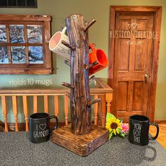 two mugs and a tree stand on a counter