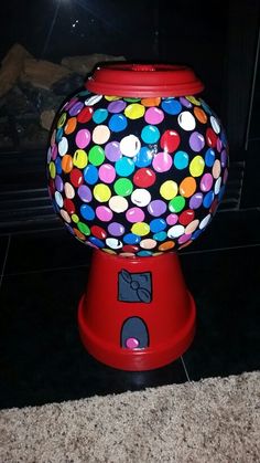 a colorful gummy ball machine sitting on the floor