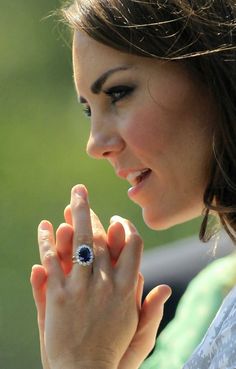 the young woman is holding her hand up to her face and looking at something in front of her