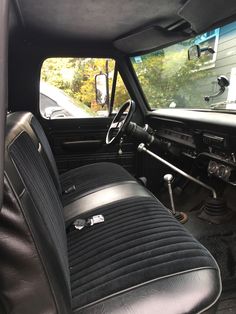 the interior of an old car with black leather seats