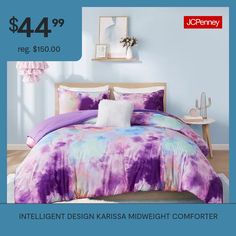 a bed with purple and blue comforters on it