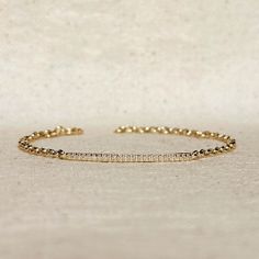 Indulge in the timeless elegance of our 18k Gold Filled 2mm CZ Bar Bracelet. With its modern and minimalist design, this bracelet adds a touch of sophistication to any outfit. The sparkling CZ bar adds a touch of glamour, making it the perfect accessory for any occasion. Elevate your style with this luxurious piece of jewelry. Metal: 18k Gold Filled High-quality Cubic Zirconia AAAAA Width: 1mm micro CZ Stones in a 2mm bar Size: 7" with 3 adjustment options at 6, 6.5 and 7 inches Hypoallergenic W Modern Stackable Tennis Bracelet, Minimalist Gold Tennis Bracelet For Everyday, Minimalist Stackable Yellow Gold Tennis Bracelet, Minimalist Yellow Gold Diamond Bracelet With Adjustable Chain, Yellow Gold Minimalist Stackable Tennis Bracelet, Minimalist Yellow Gold Stackable Tennis Bracelet, Minimalist Formal Tennis Bracelet With Adjustable Chain, Minimalist Adjustable Chain Tennis Bracelet For Formal Occasions, Minimalist White Gold Everyday Luxury Bracelet