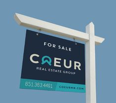 a real estate sign for sale in front of a blue sky with the words coeur on it