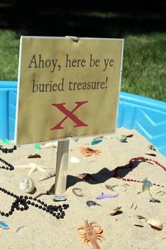 there is a sign that says, ahoy, here be ye buried treasures in the sand