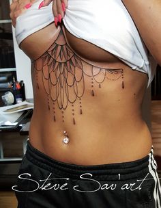 a woman is showing off her stomach tattoo