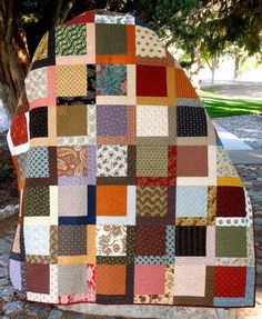 a quilted blanket is shown on the cover of a book, called needle and needle quilt