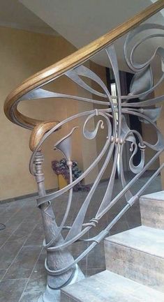 a metal stair railing in a house with tile flooring