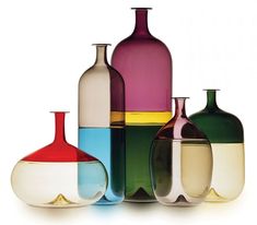 several different colored vases sitting next to each other