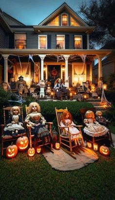 halloween decorations in front of a house with pumpkins