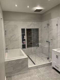 a bathroom with a walk in shower next to a bath tub